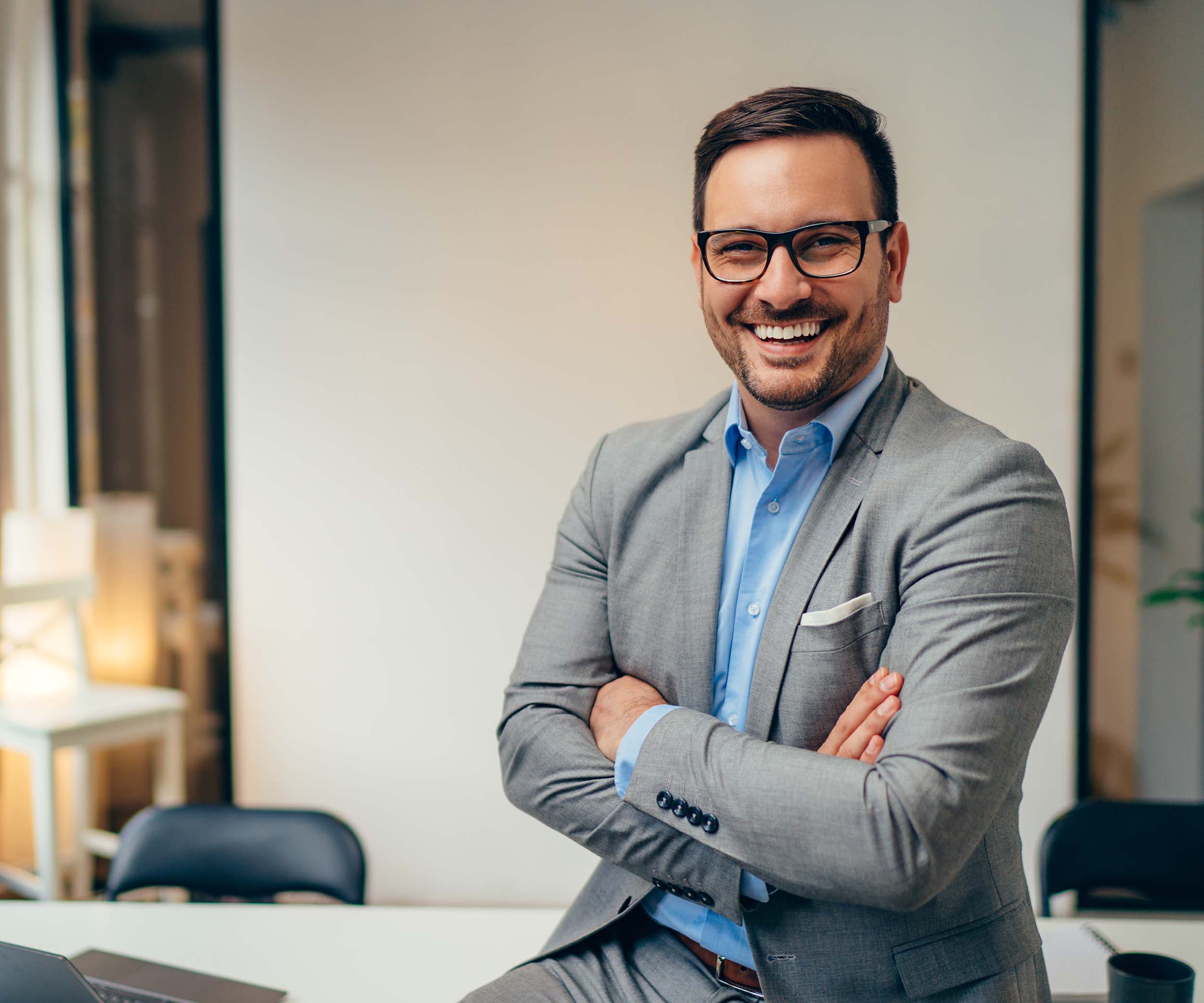 Portrait,Of,Young,Happy,Businessman,Wearing,Grey,Suit,And,Blue